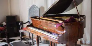 A piano sitting in the middle of a room.