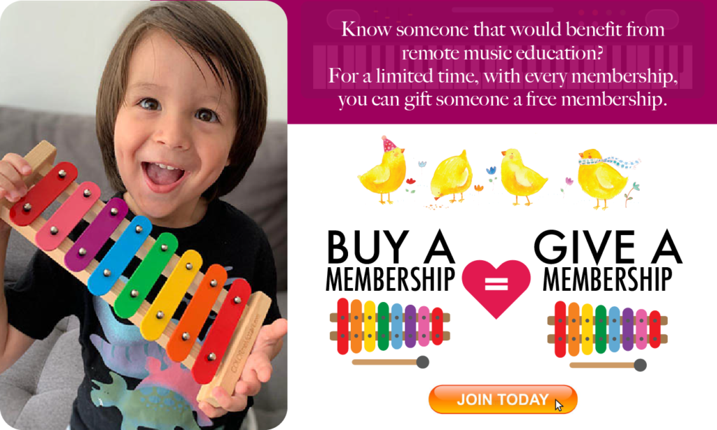 A child holding up some instruments with a heart on it