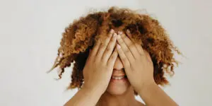 A woman covering her eyes with her hands.