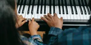 A person playing the piano with their hands