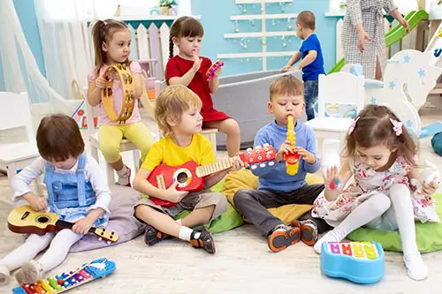 A group of children sitting on the floor playing with toys.