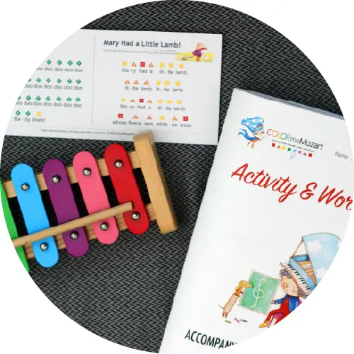 A child 's activity book and xylophone.