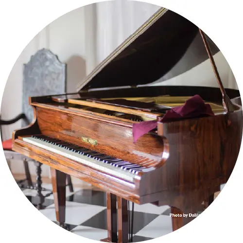 A piano sitting on top of a wooden bench.