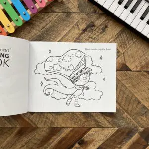 A coloring book sitting on top of a wooden table.