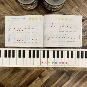 A book with music notes and a piano keyboard.