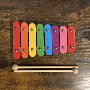 A wooden xylophone with eight colored bars.