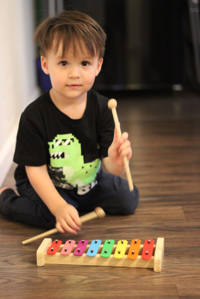 Preschooler playing xylophone