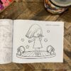 A coloring book sitting on top of a table.