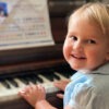 A little girl is playing the piano