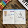 A book with music notes and a piano keyboard