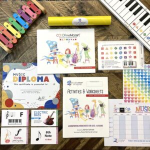 A table with several different books and music instruments.