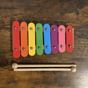 A wooden xylophone with eight colored bars.