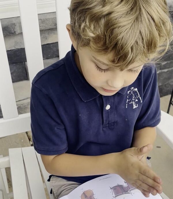 A young boy sitting on top of a chair.